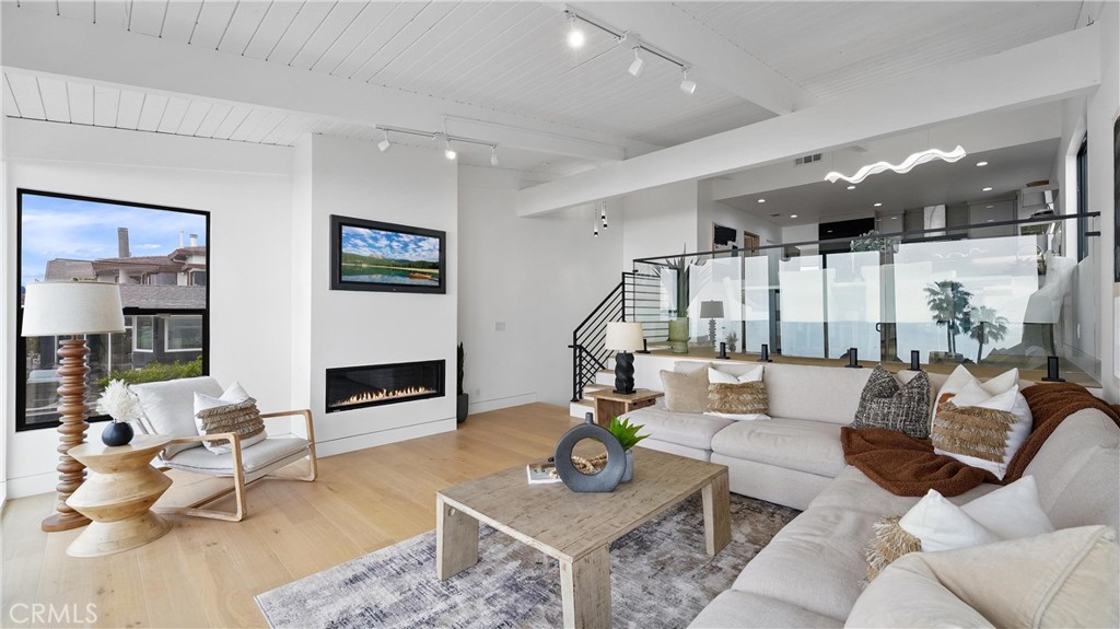 Light-filled living room with an open and airy feel, showcasing ocean and white-water views. - 1095 Miramar, Laguna Beach CA 92651 - photo 10