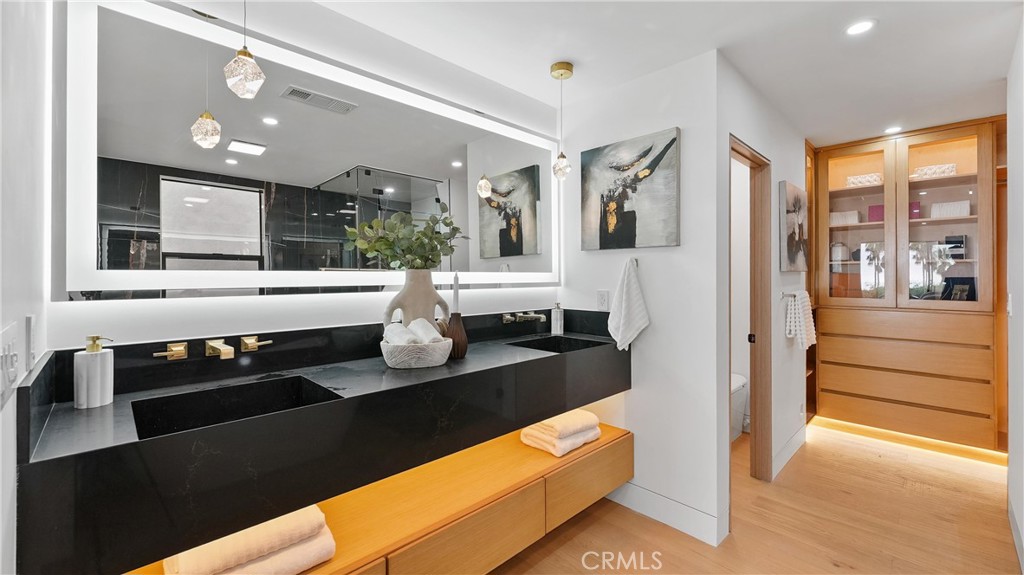 Enjoy a true retreat in the primary bathroom with steam shower, dual custom vanity sinks, and custom walk-in closets. - 1095 Miramar, Laguna Beach CA 92651 - photo 29