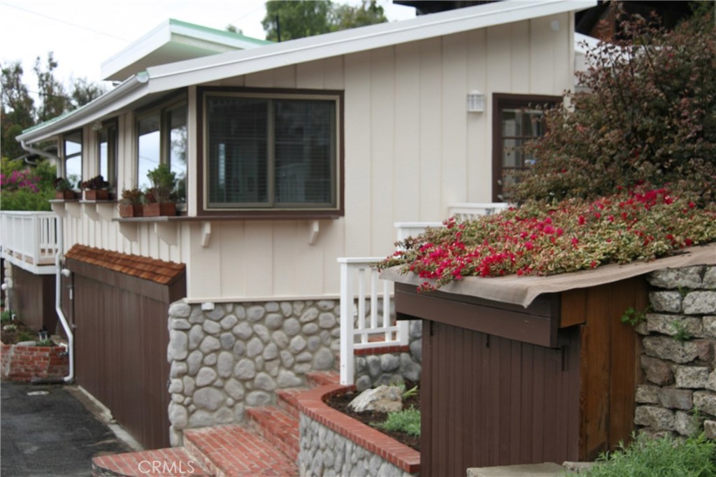 Beautiful cottage looking west. Viewing kitchen windows, cute shed and steps to three large back decks. - 1160 Jefferson Way, Laguna Beach CA 92651 - photo 1