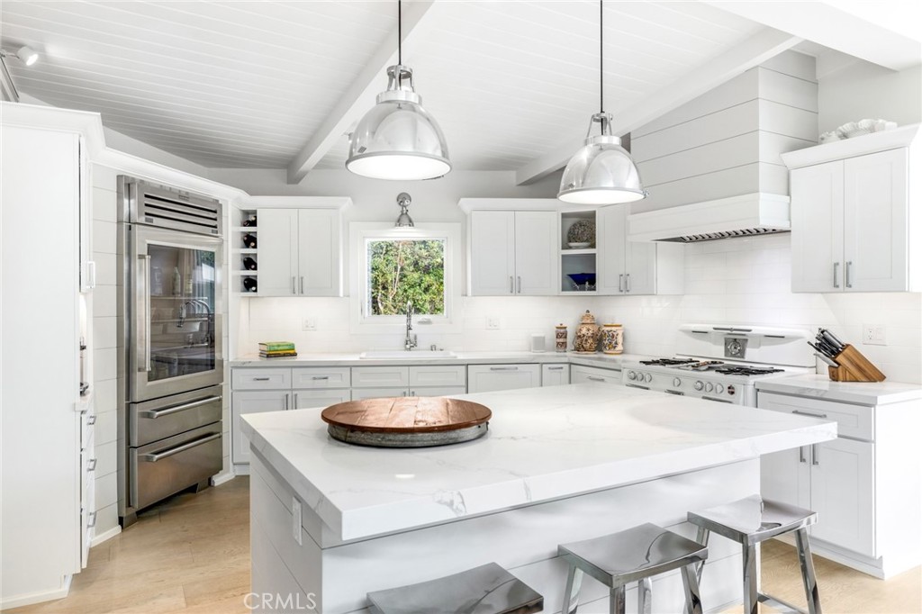 As chic as it is functional, the newly upgraded kitchen pampers chefs with a large island with bar seating. - 1279 Temple Terrace, Laguna Beach CA 92651 - photo 1