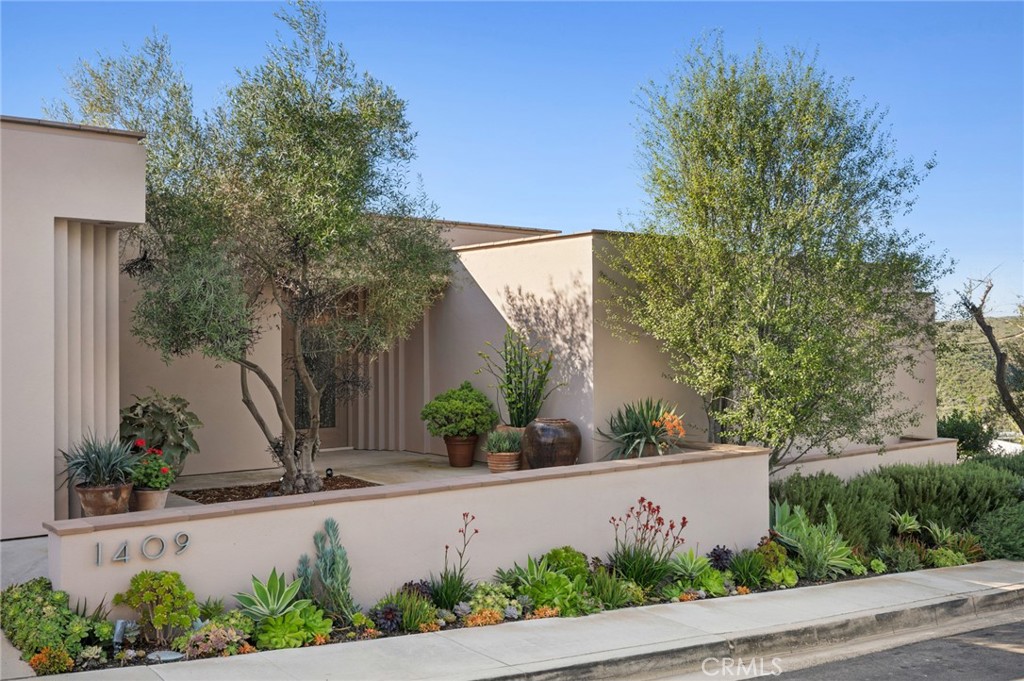 Low-maintenance, water-wise landscaping surrounds the residence, complementing the limestone decks and outdoor living ar - 1409 Samoa Way, Laguna Beach CA 92651 - photo 3