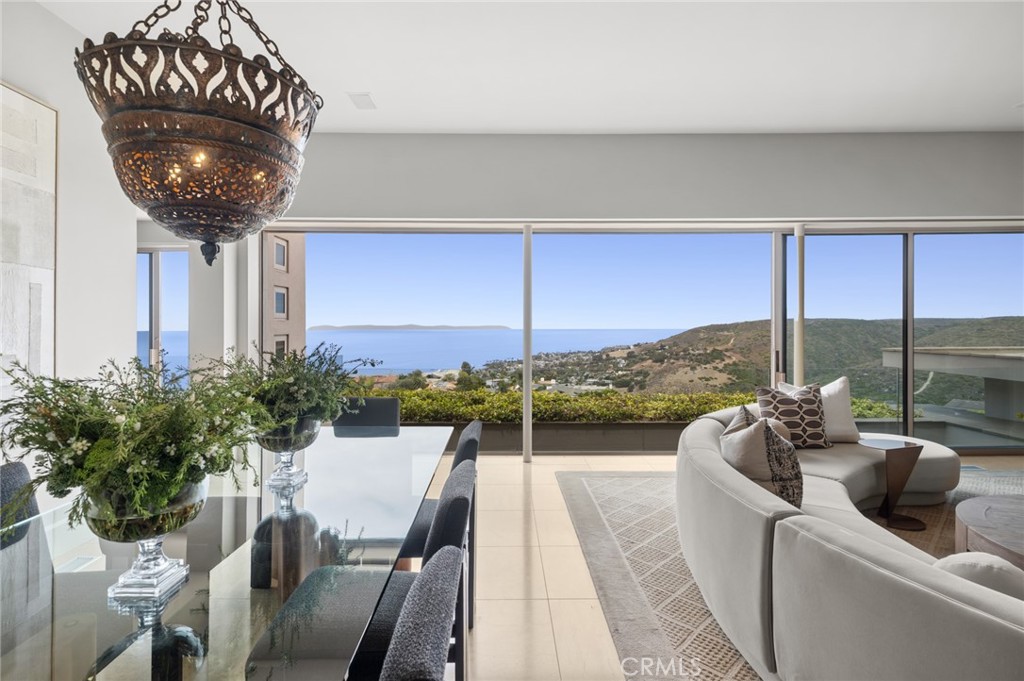 The living room serves as a striking gathering space, highlighted by a gas fireplace with a black granite surround and M - 1409 Samoa Way, Laguna Beach CA 92651 - photo 8