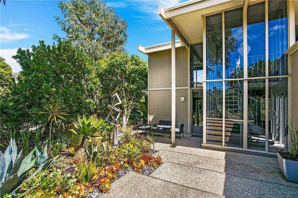 Front door of this Mid Century home Lots of glass and great style. Hardwood floors throughout the house - 1494 Bluebird Canyon Drive, Laguna Beach CA 92651 - photo 1