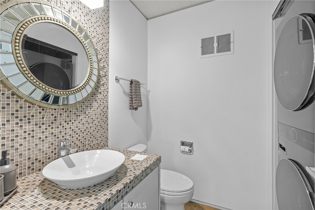 downstairs half bathroom with washer dryer - 1494 Bluebird Canyon Drive, Laguna Beach CA 92651 - photo 23