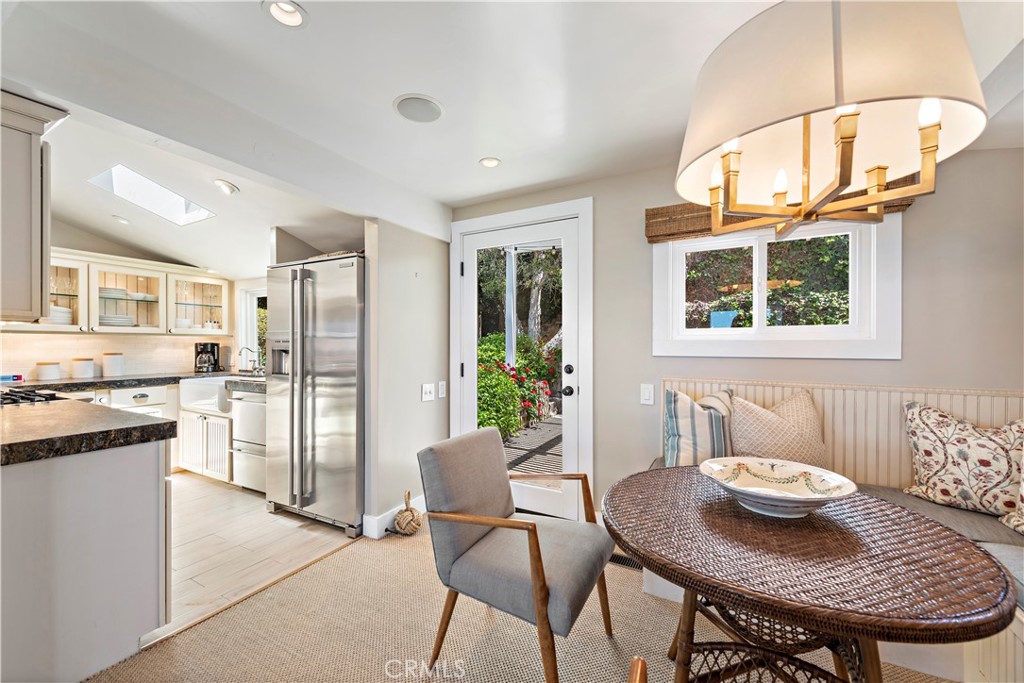 Dining nook, kitchen and rear access to outdoor dining and yard. - 151 Rockledge, Laguna Beach CA 92651 - photo 16