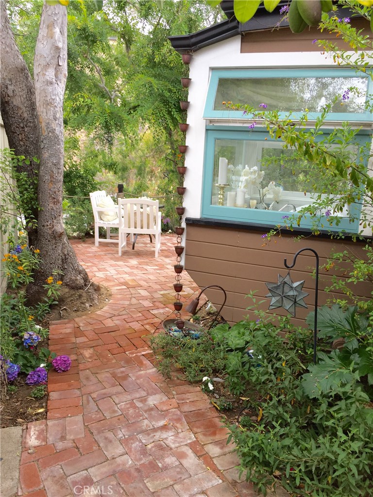 Enter your private aged brick courtyard under a canape of trees. - 160 High Drive A, Laguna Beach CA 92651 - photo 1