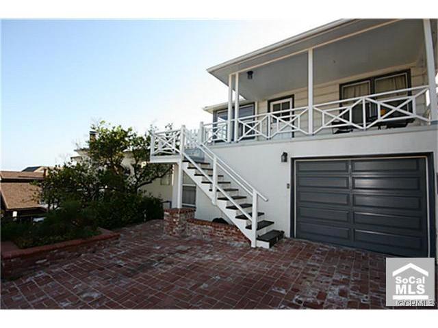 Entry is located on west side of garage with small porch outside of front door~ - 160 McAulay Place lower, Laguna Beach CA 92651 - photo 1
