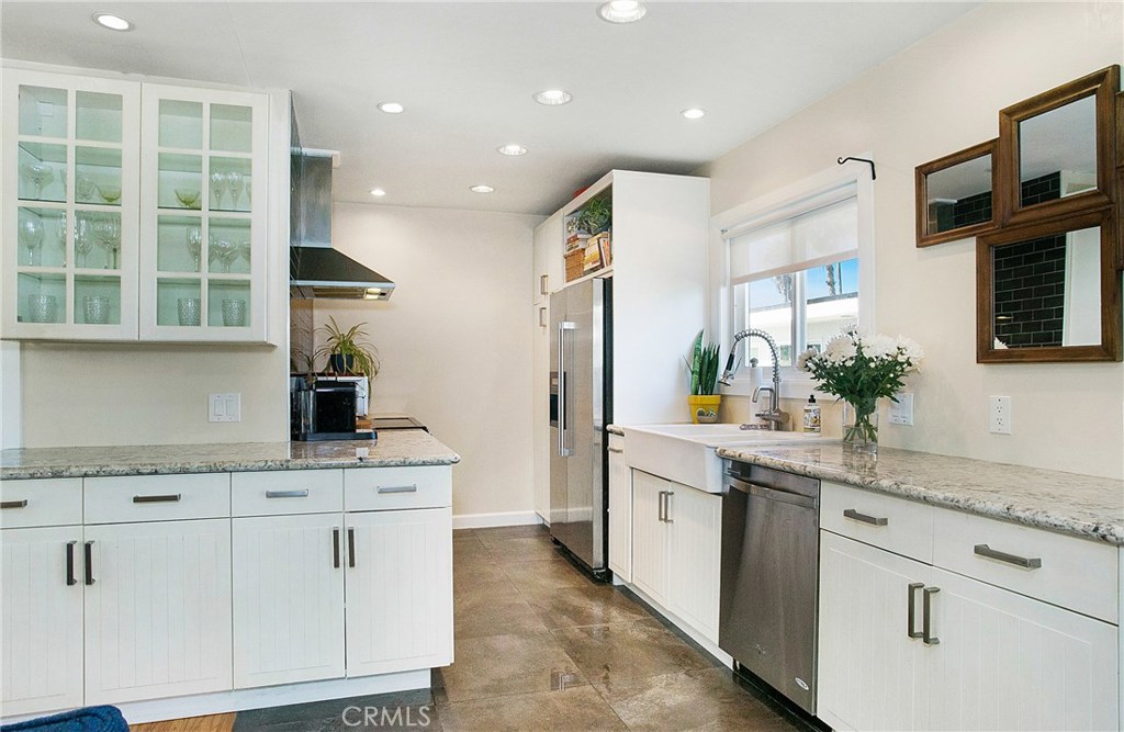 Enter into your beautiful, modern kitchen with light granite, stainless appliances, and abundant storage. - 179 Mcknight Drive 8, Laguna Beach CA 92651 - photo 1