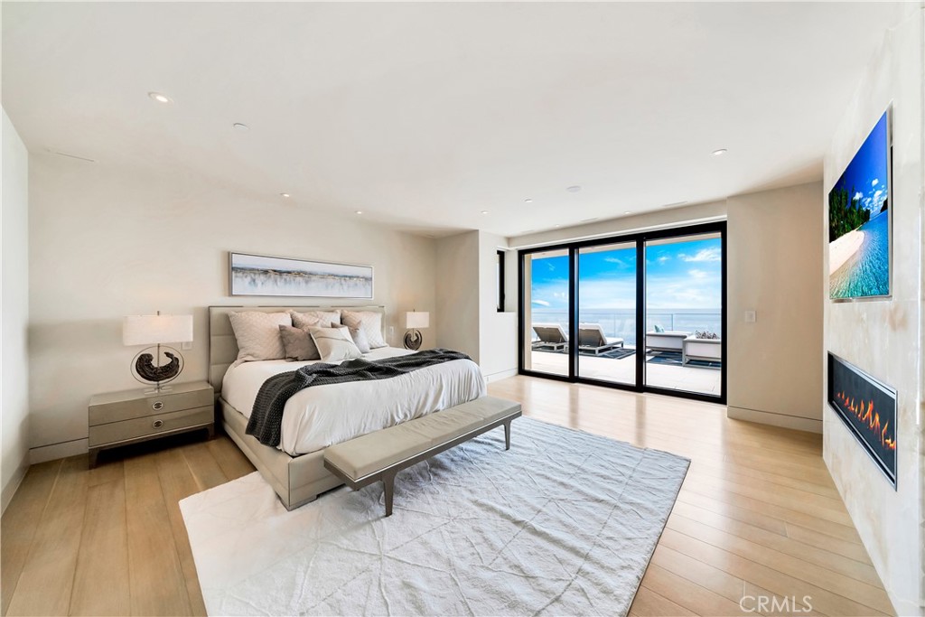 Primary suite with patio doors, built ins, tv & fireplace - 18 Lagunita Drive, Laguna Beach CA 92651 - photo 13