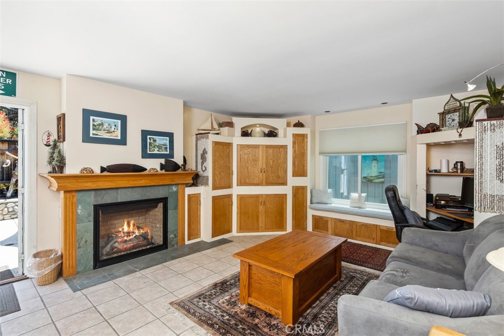 Family Room with Tile Floors and Fireaplce. Open to Backyard - 181 SUNSET Terrace, Laguna Beach CA 92651 - photo 14