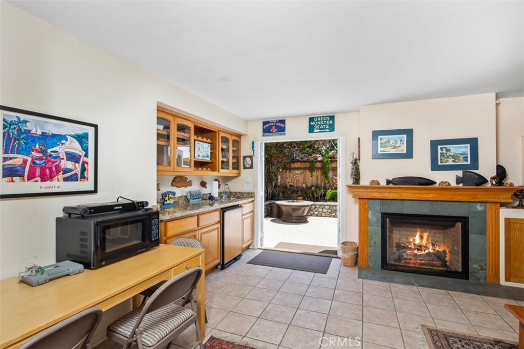 First level family Room with Fireplace. Doors to Backyard - 181 SUNSET Terrace, Laguna Beach CA 92651 - photo 13