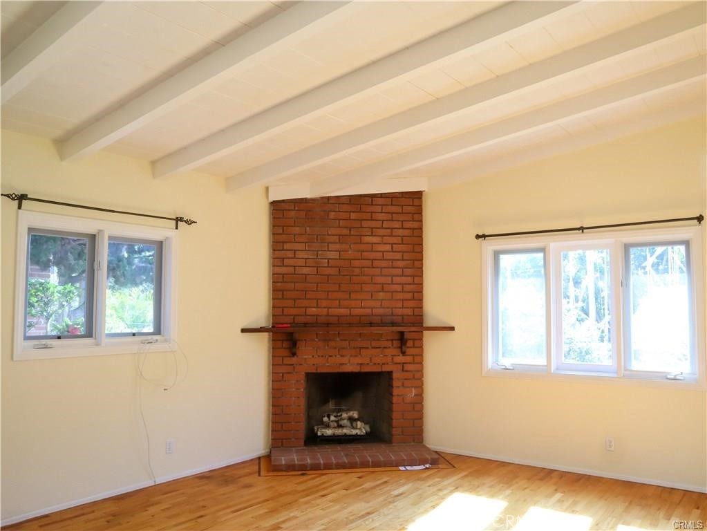 Yes, a handsome vaulted open beam ceiling; beautiful hardwood floors; and, a marvelous fireplace. - 1821 Glenneyre Street, Laguna Beach CA 92651 - photo 1