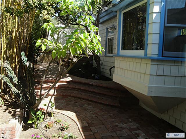 Brick patio and bay window of Bedroom three - 1945 GLENNEYRE Street, Laguna Beach CA 92651 - photo 1