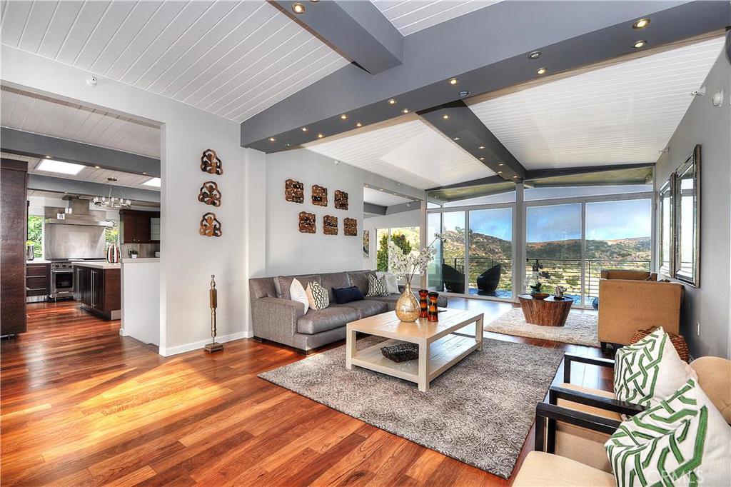 Enter into the living room with beautiful wood floors, high ceilings, and wall of windows leading to expansive deck with - 2085 Temple Hills Drive, Laguna Beach CA 92651 - photo 1