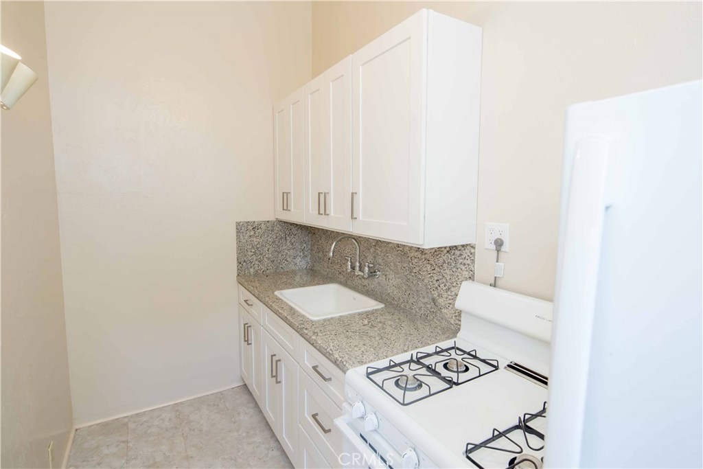 Newly remodeled kitchen. New cabinets, sink, faucet and granite counter top. - 209 Cypress Drive A, Laguna Beach CA 92651 - photo 1