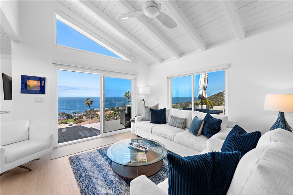 Relax in the family room as the ocean dances in the light. - 21657 Ocean Vista Drive 19, Laguna Beach CA 92651 - photo 1
