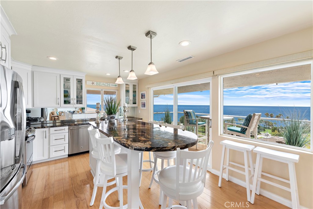 Fully remodeled kitchen with large center island. - 21682 Ocean Vista Drive D, Laguna Beach CA 92651 - photo 7