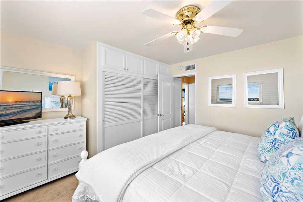 Master bedroom sliding closet storage. - 21682 Ocean Vista Drive D, Laguna Beach CA 92651 - photo 11