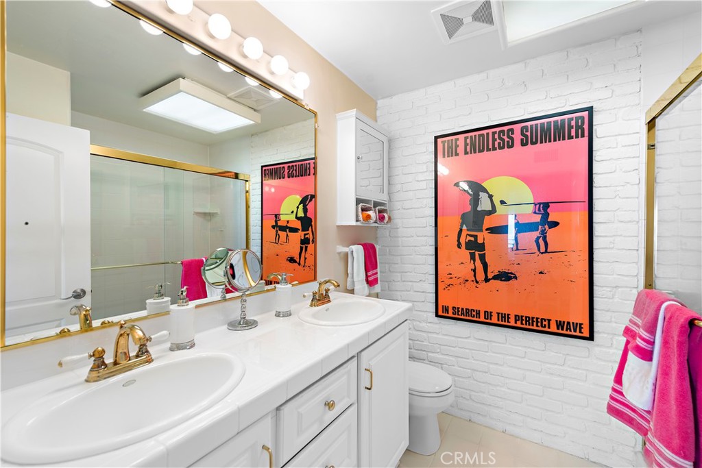 Bathroom with dual sinks, tiled shower. - 21682 Ocean Vista Drive D, Laguna Beach CA 92651 - photo 12