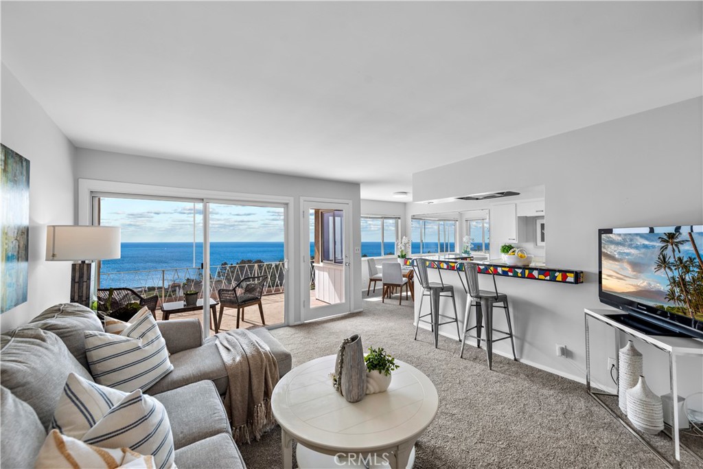 Living room with kitchen bar seating. - 21722 Ocean Vista Drive F, Laguna Beach CA 92651 - photo 5
