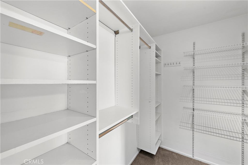 Walk in closet with mirrored doors. - 21722 Ocean Vista Drive F, Laguna Beach CA 92651 - photo 11