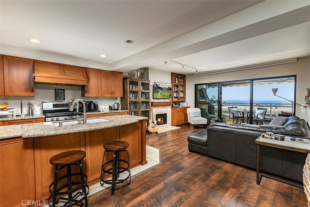 Remodeled open kitchen with the living room and ocean views beyond. - 21771 Ocean Vista Drive 29, Laguna Beach CA 92651 - photo 1