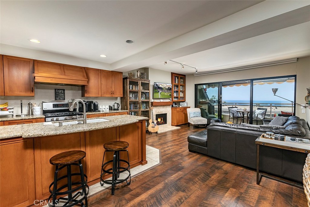 Remodeled open kitchen with the living room and ocean views beyond. - 21771 Ocean Vista Drive 29, Laguna Beach CA 92651 - photo 1