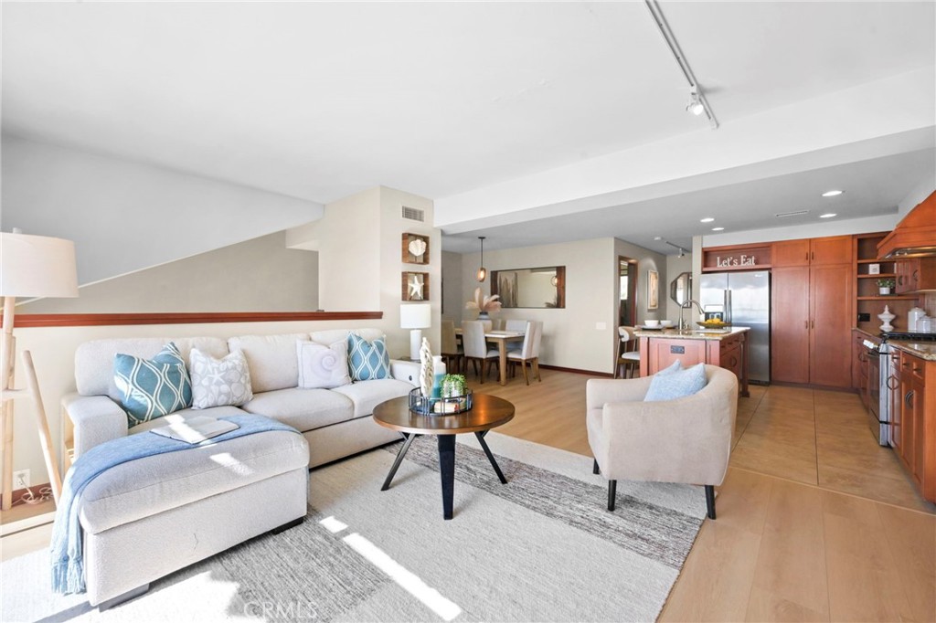 A view of the living room, kitchen and dining room. - 21771 Ocean Vista Drive 29, Laguna Beach CA 92651 - photo 4