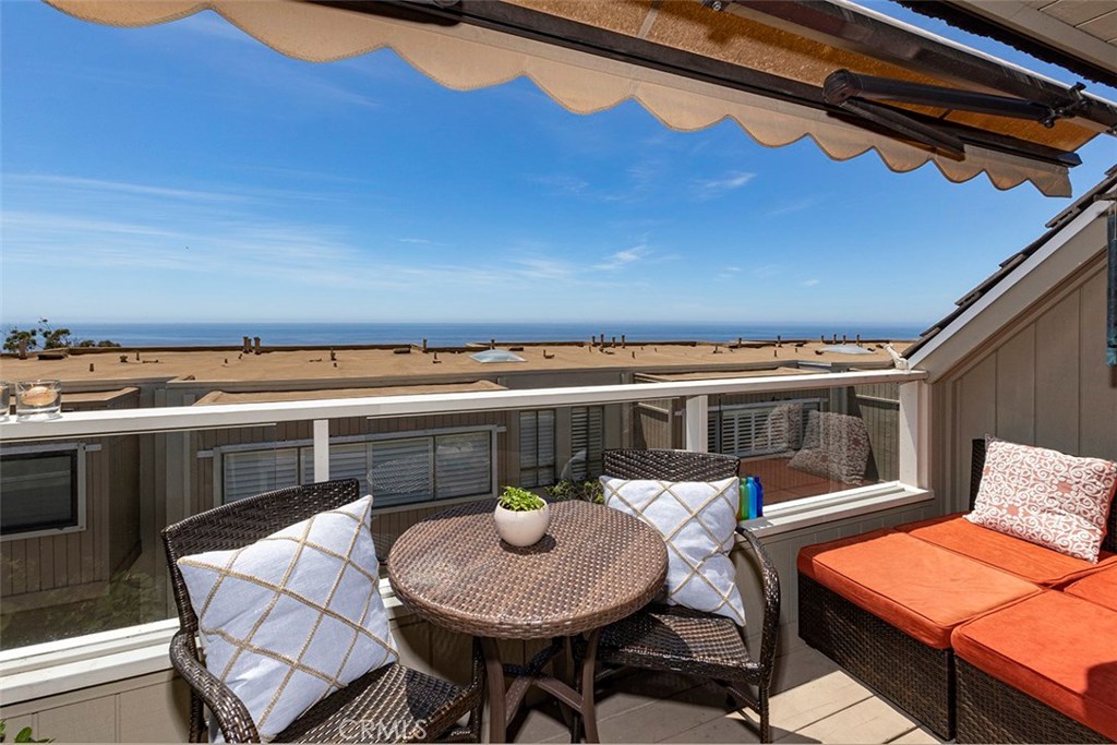 A view of the deck off the living room, with an expandable awning. - 21771 Ocean Vista Drive 29, Laguna Beach CA 92651 - photo 9