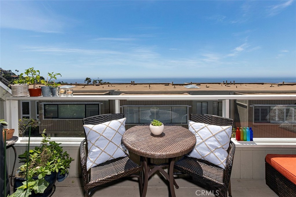 Sunny south-west facing deck off the living room, with great ocean views. - 21771 Ocean Vista Drive 29, Laguna Beach CA 92651 - photo 10