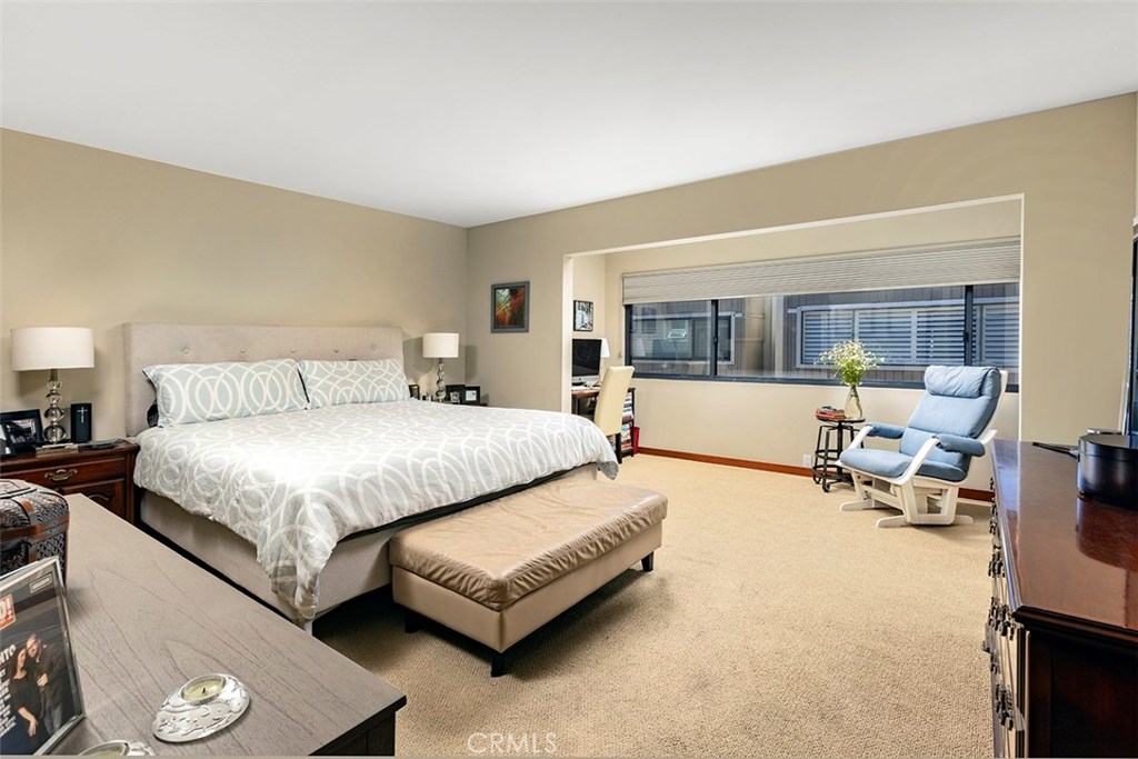 The primary bedroom with an alcove beyond that has room for an office or sitting area. - 21771 Ocean Vista Drive 29, Laguna Beach CA 92651 - photo 16
