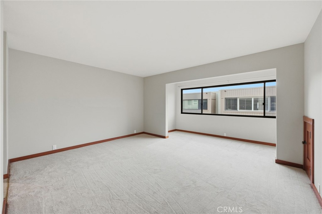 This is a current photo of the primary suite which has brand new carpeting! - 21771 Ocean Vista Drive 29, Laguna Beach CA 92651 - photo 17