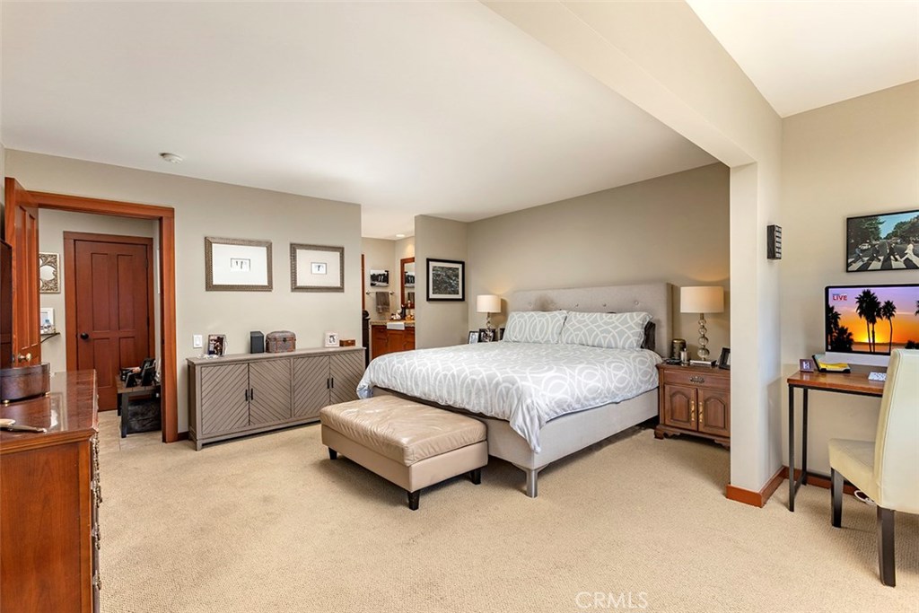 Another view of the large primary bedroom with the attached bath beyond. - 21771 Ocean Vista Drive 29, Laguna Beach CA 92651 - photo 18