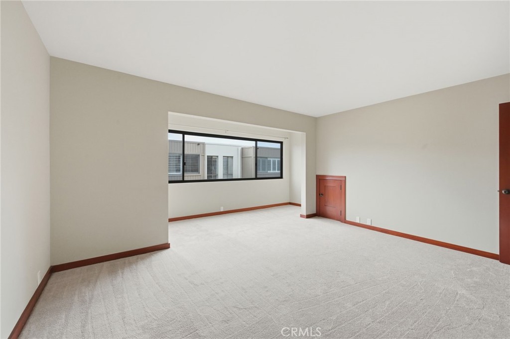 The current picture of the primary suite with new carpeting. - 21771 Ocean Vista Drive 29, Laguna Beach CA 92651 - photo 20