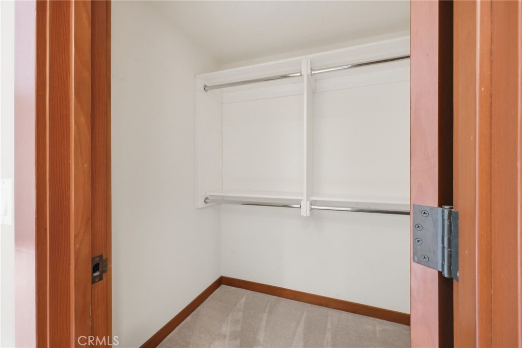 The walk-in closet in the primary suite. - 21771 Ocean Vista Drive 29, Laguna Beach CA 92651 - photo 23