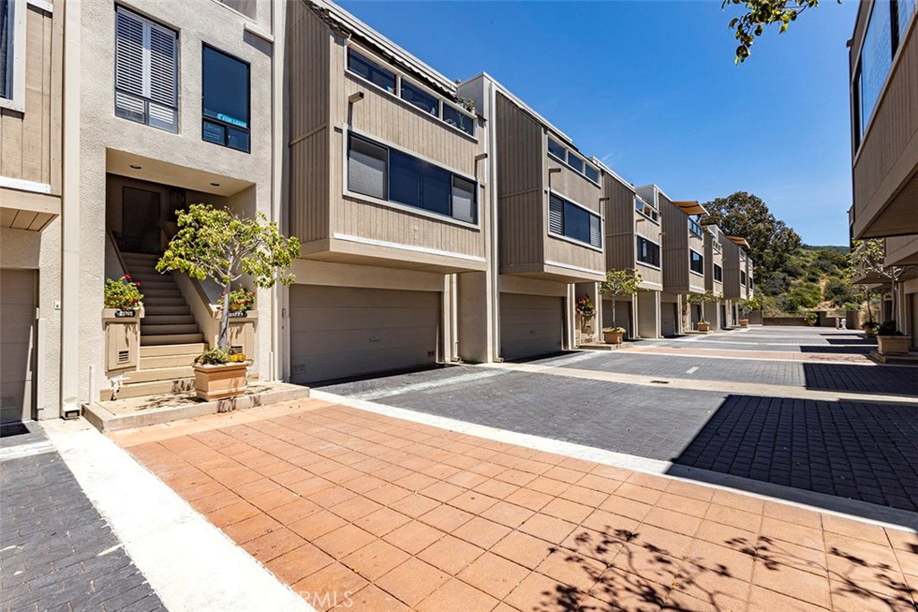 Here is a view of the 2 car garage and the entrance to the front door. The community pool is at the end of the street, 6 - 21771 Ocean Vista Drive 29, Laguna Beach CA 92651 - photo 30