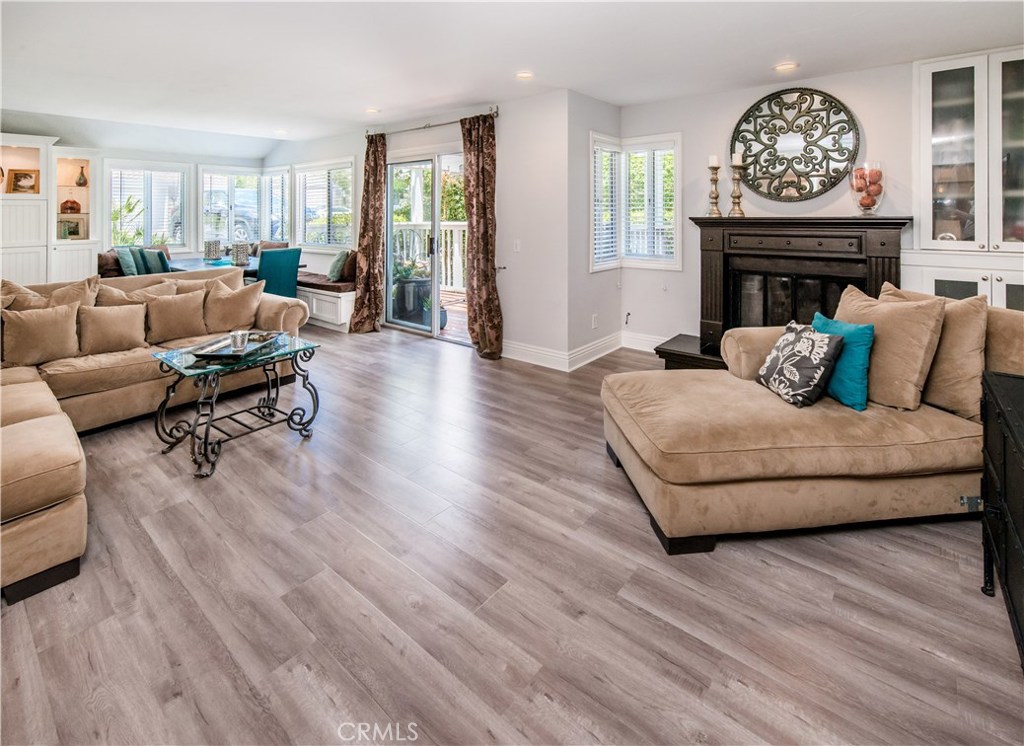 Living room with fireplace is open to dining area and patio. New laminate wood floors, enhanced mantel. New LED lights, - 222 Santa Rosa Court, Laguna Beach CA 92651 - photo 1