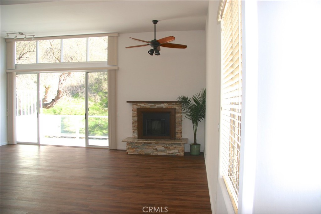 Spacious living room with fireplace and view. Picture prior tenant - 2375 Laguna Canyon Road, Laguna Beach CA 92651 - photo 9