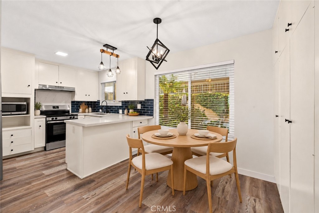 Remodeled kitchen, new quartz counters, appliances, lighting, tile backsplash. (Virtual stage) - 240 Moss 2, Laguna Beach CA 92651 - photo 6