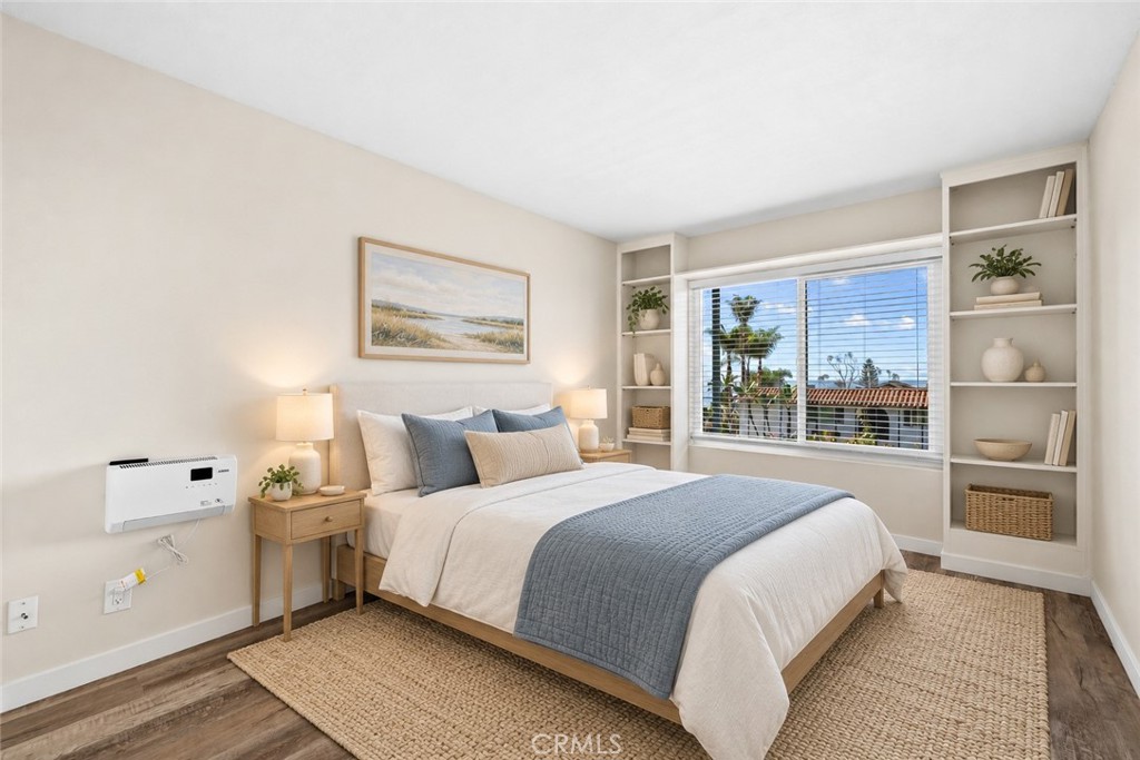 Secondary bedroom with built in bookcases (virtual stage) - 240 Moss 2, Laguna Beach CA 92651 - photo 15