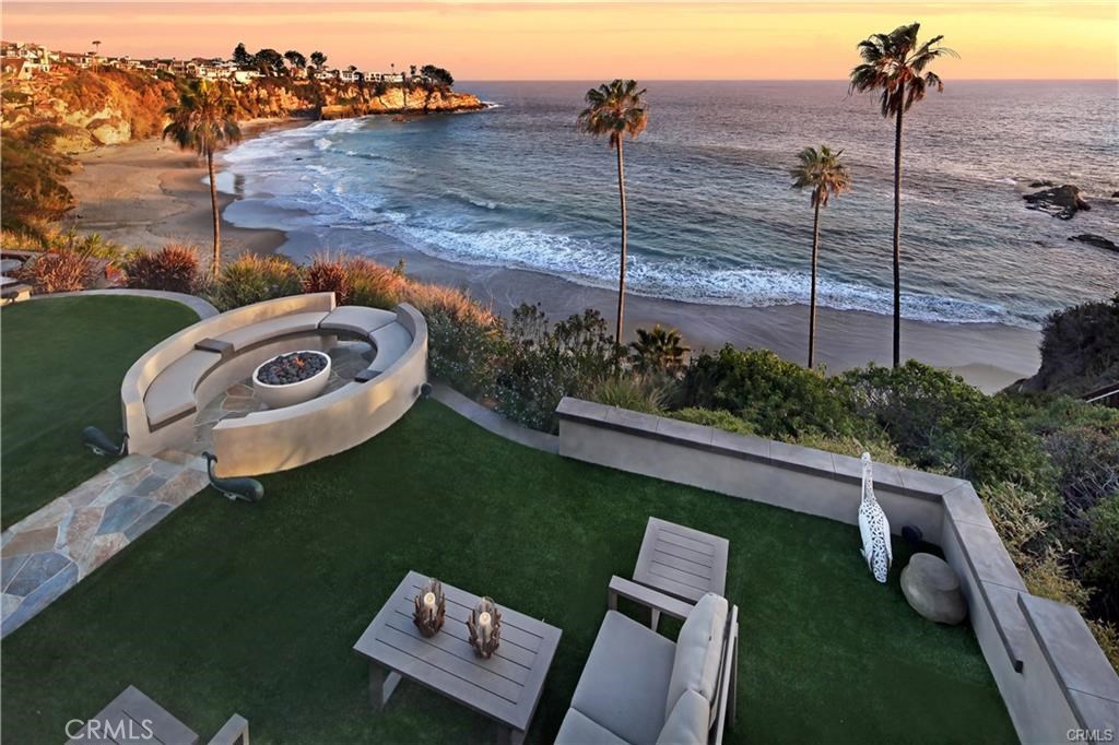 Your own private resort enclave in gate guarded Thrre Arch Bay in South Laguna. View from upper patio to lower lawn and - 26 S La Senda Drive, Laguna Beach CA 92651 - photo 1