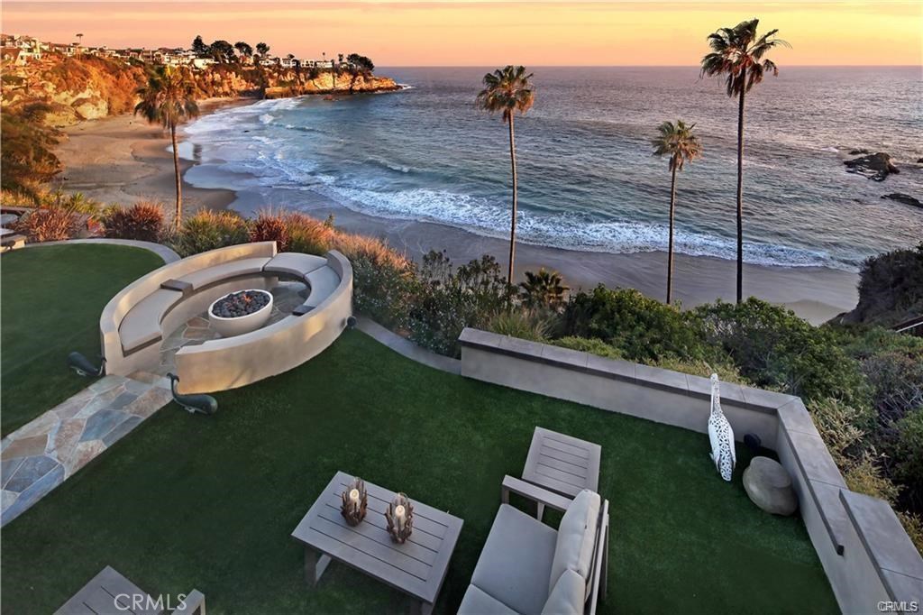 Your own private resort enclave in gate guarded Thrre Arch Bay in South Laguna. View from upper patio to lower lawn and - 26 S La Senda Drive, Laguna Beach CA 92651 - photo 1