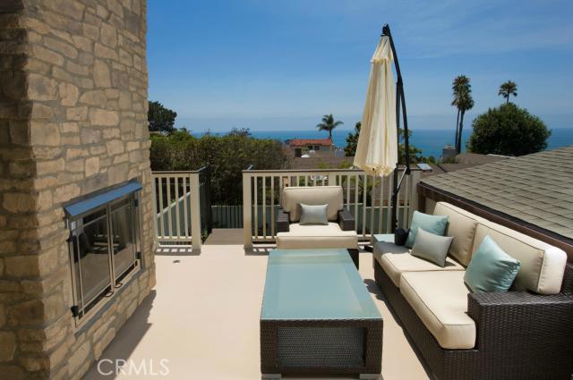 Welcome home to lower Three Arch Bay! Enjoy beautiful indoor/outdoor living spaces with ocean views and fireplaces. - 26 S Portola, Laguna Beach CA 92651 - photo 1