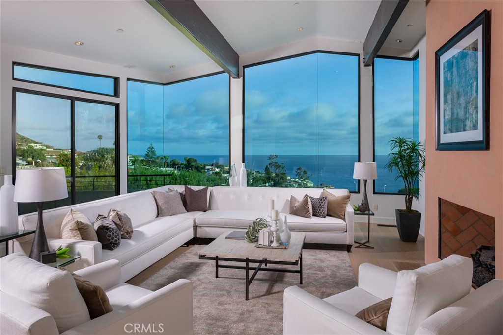 Enter the main level to the living room with white-water ocean and coastal views. - 261 Highland Road, Laguna Beach CA 92651 - photo 1