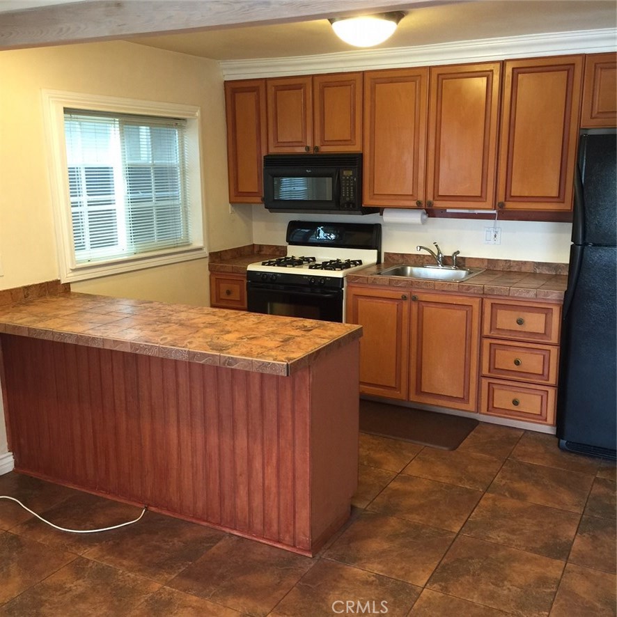 Remodeled Kitchen with Granite Counters and Breakfast Bar - 274 Cliff Drive 3, Laguna Beach CA 92651 - photo 1