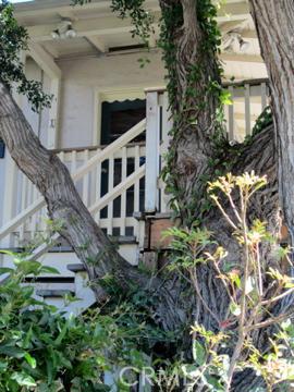 Stairway to the apartment's wrap-around deck. Kitchen door is in this photo. - 275 Cypress Drive A, Laguna Beach CA 92651 - photo 1