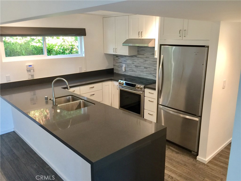 Beautiful quartz countertops, newer stainless steel appliances, and breakfast bar. - 287 San Joaquin Drive, Laguna Beach CA 92651 - photo 1