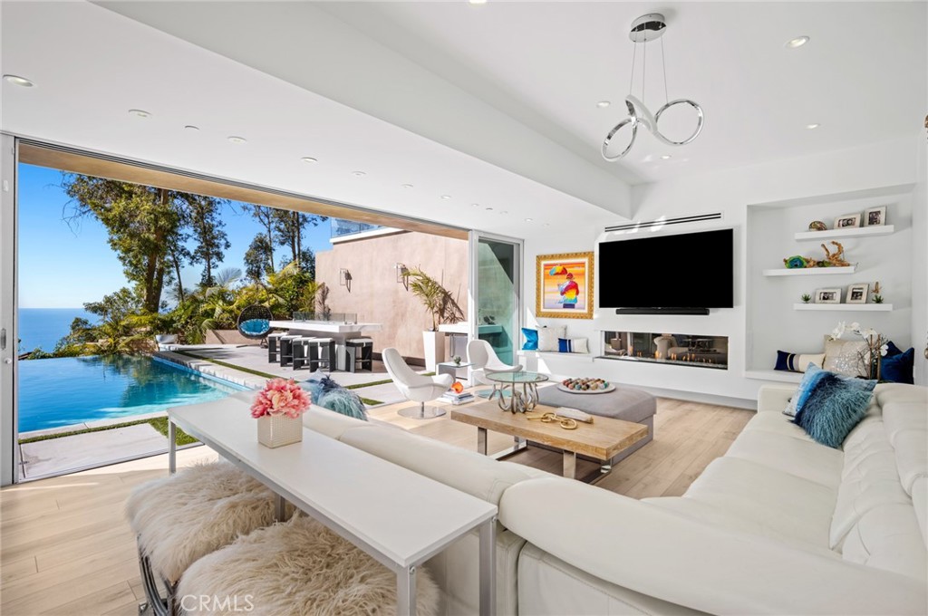 Downstairs, a versatile oversized bonus room offers ocean views and opens to the backyard’s pool and spa, providing a gr - 28911 Sommet Du Monde, Laguna Beach CA 92651 - photo 1