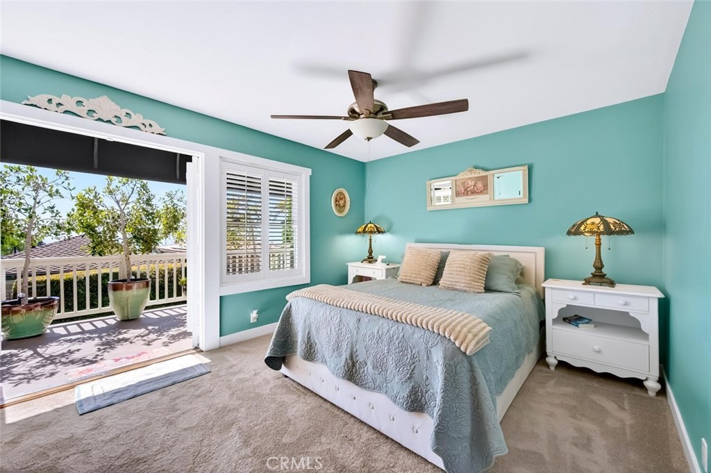 Primary bedroom with French doors out to a peaceful ocean view deck. - 2896 Terry Rd, Laguna Beach CA 92651 - photo 29