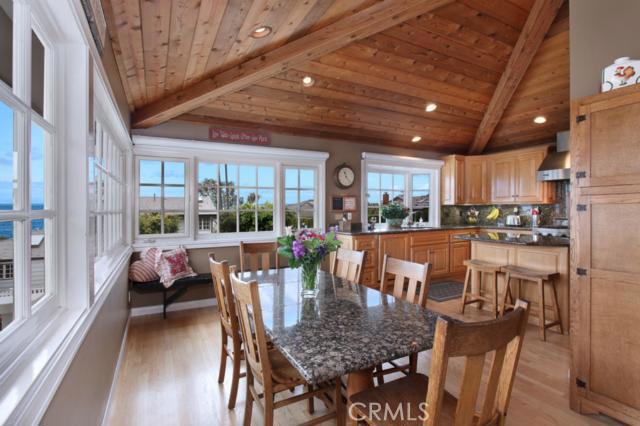 The dining room flows seamlessly into the kitchen with tons of natural light and ocean views - 3 S Vista De La Luna, Laguna Beach CA 92651 - photo 1